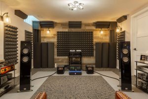 High-end basement audio room in Toronto with professional sound equipment, acoustic panels, and a sophisticated music listening area.