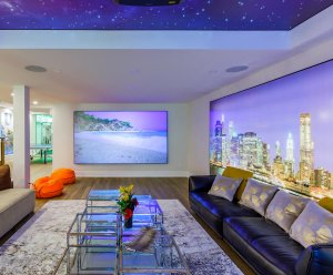 Luxury basement renovation in Toronto with a beach scene projector, a night sky ceiling, and a vibrant cityscape mural, showcasing sophisticated basement finishing.