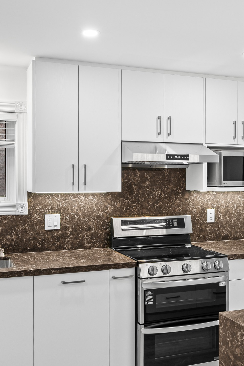 Compact Kitchen Layout with Range and Fridge from a real Capable Group kitchen renovation.