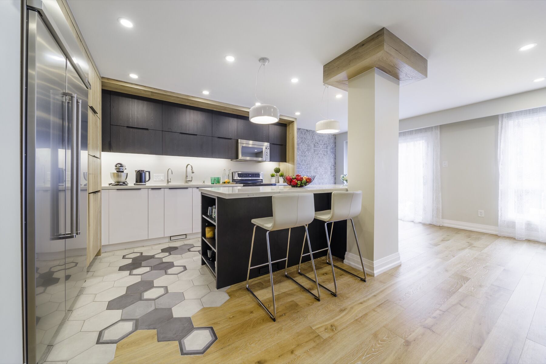 Completed Richmond Hill full-home renovation with an open kitchen, island, dining area and connected living space.